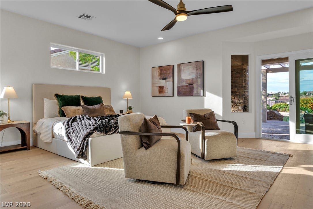 2734 Cherrydale Falls Drive, Henderson, NV 89052 Rich wood floors and massive sliding doors define this serene, modern bedroom suite.
