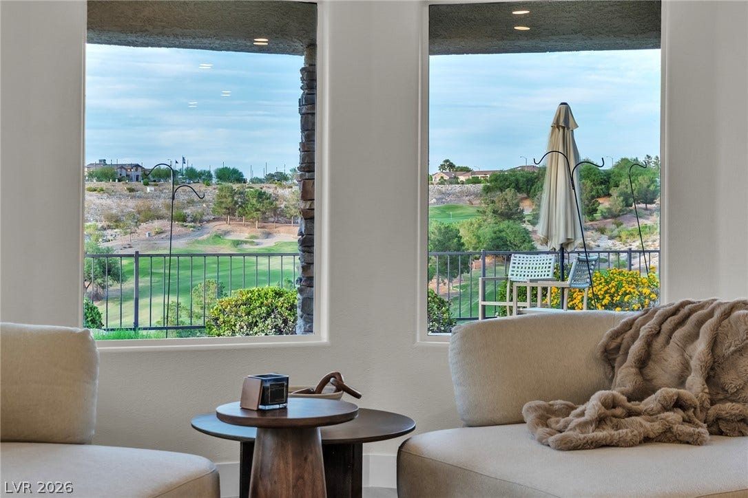 2734 Cherrydale Falls Drive, Henderson, NV 89052 Large picture windows frame rolling green golf course views.