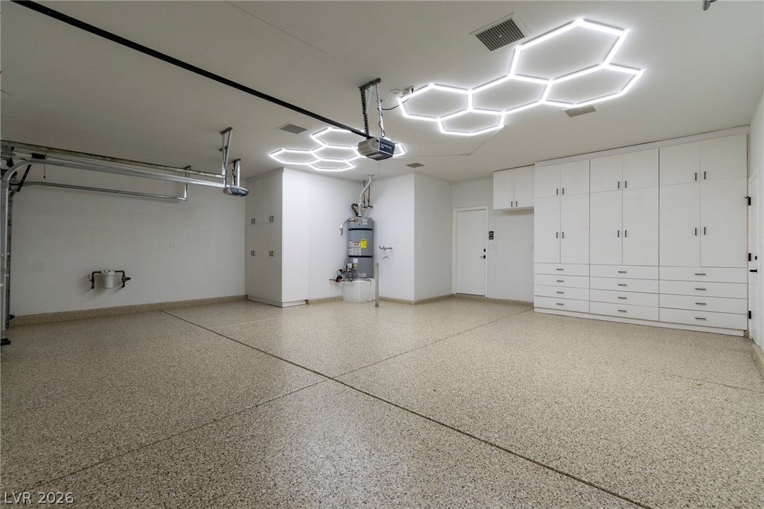 2734 Cherrydale Falls Drive, Henderson, NV 89052 Custom ceiling lighting and extensive built-in cabinetry elevate this pristine finished garage space.