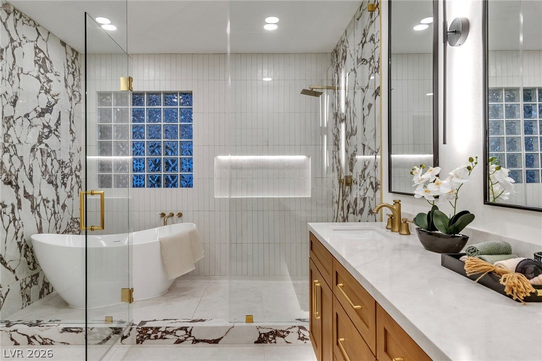 2734 Cherrydale Falls Drive, Henderson, NV 89052 Elegant stone finishes and a sleek soaking tub define this modern primary bath sanctuary.