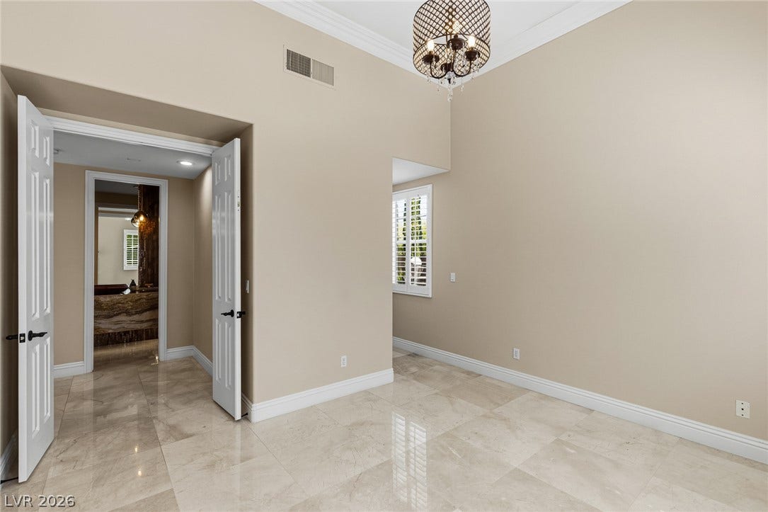 204 Satin Mist Court, Las Vegas, NV 89144 Gleaming stone flooring and high ceilings with classic crown molding elevate this versatile room.