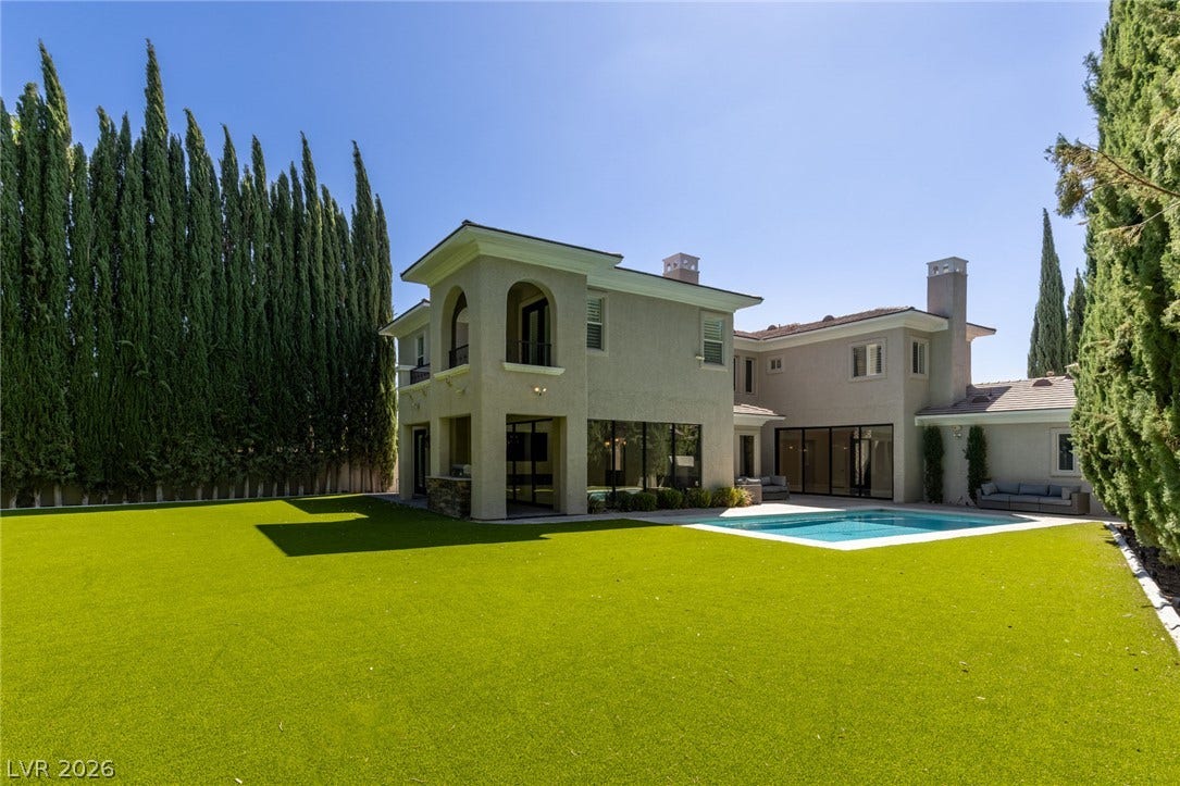 204 Satin Mist Court, Las Vegas, NV 89144 A spacious green lawn sits beside the sparkling backyard swimming pool.