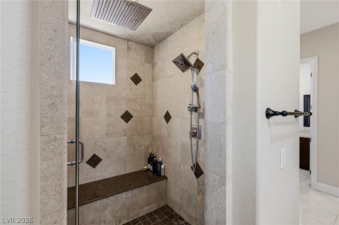 204 Satin Mist Court, Las Vegas, NV 89144 Floor-to-ceiling tilework and a built-in bench elevate this walk-in shower.