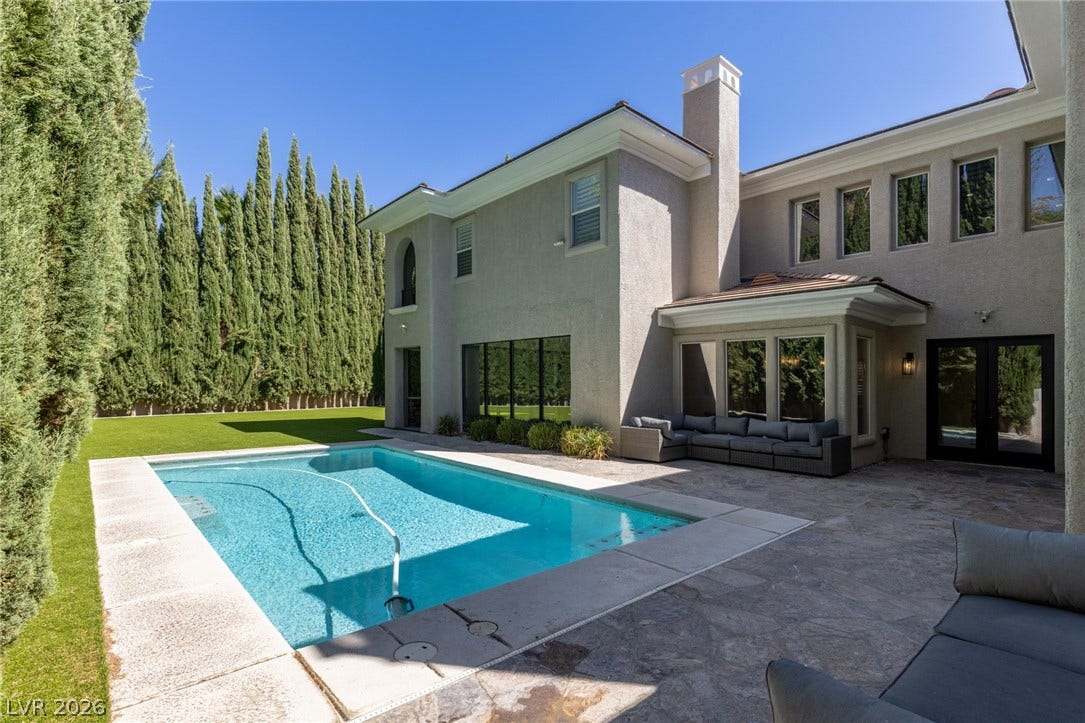 204 Satin Mist Court, Las Vegas, NV 89144 An inviting backyard oasis features a pristine swimming pool and spacious stone patio.