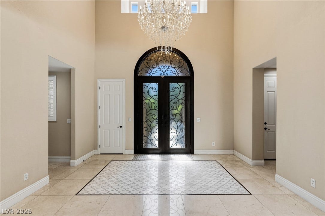 204 Satin Mist Court, Las Vegas, NV 89144 An arched double entry door and polished tile flooring define this soaring foyer.