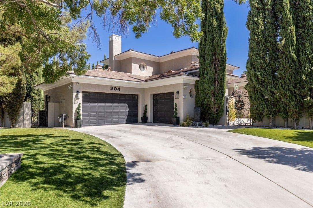 204 Satin Mist Court, Las Vegas, NV 89144 Mature trees frame the sweeping concrete driveway leading to this elegant multi-level residence.