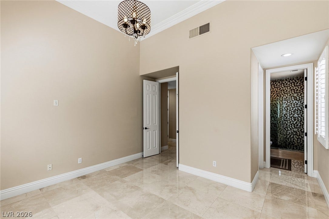 204 Satin Mist Court, Las Vegas, NV 89144 Gleaming stone tile floors and towering ceilings create an airy, upscale interior ambiance.