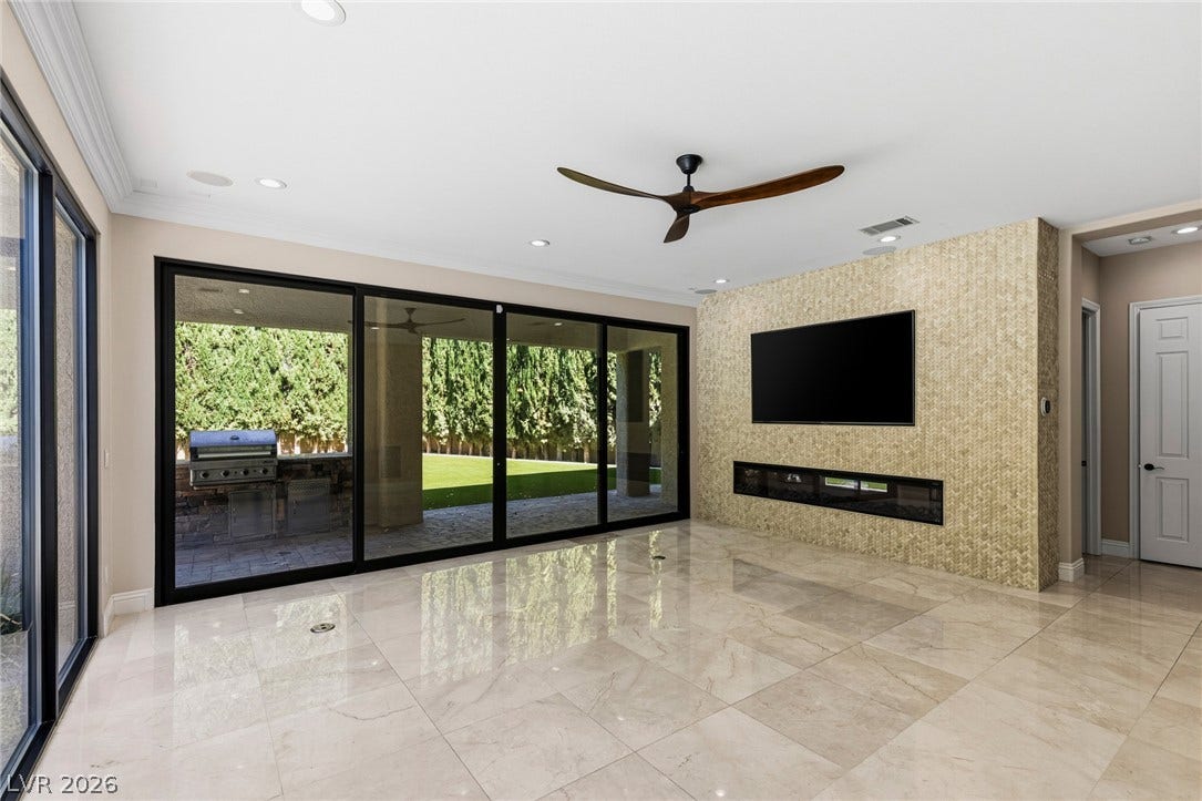 204 Satin Mist Court, Las Vegas, NV 89144 Gleaming tile floors and sliding glass walls define this open interior space.