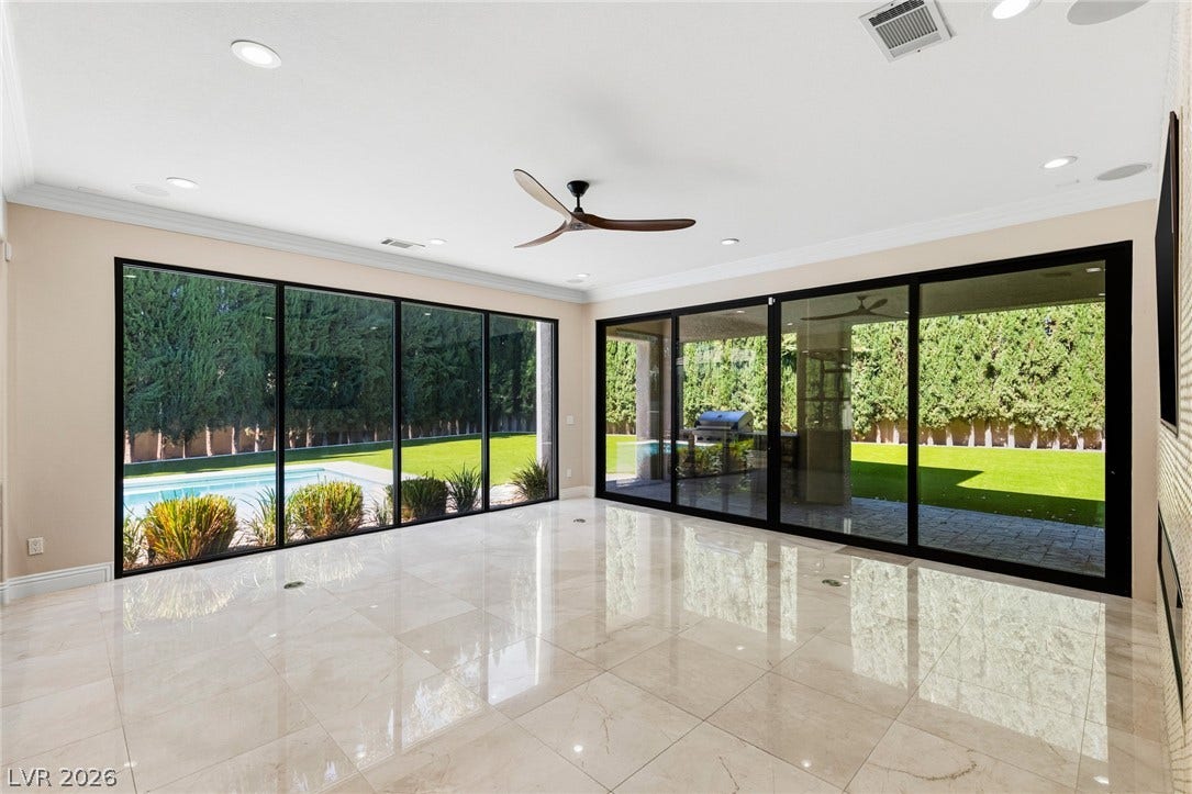 204 Satin Mist Court, Las Vegas, NV 89144 Polished tile flooring and expansive sliding glass doors connect this space directly to the backyard.