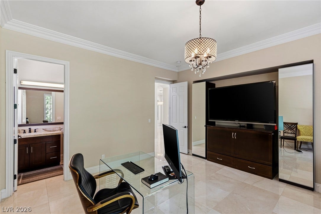 204 Satin Mist Court, Las Vegas, NV 89144 Polished tile flooring and detailed crown molding enhance this versatile home office environment.