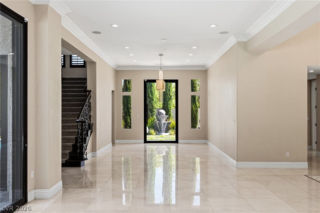 204 Satin Mist Court, Las Vegas, NV 89144 Polished tile flooring and crown molding frame a grand entrance foyer with courtyard views.