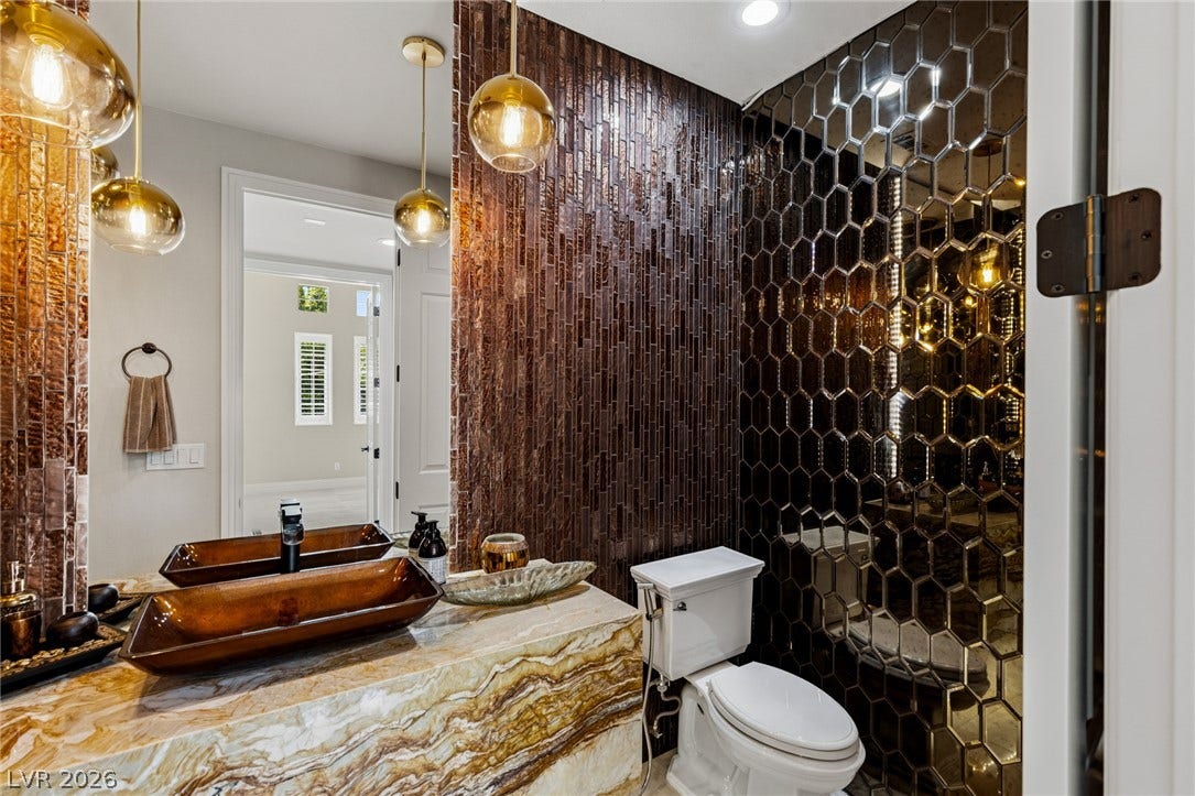 204 Satin Mist Court, Las Vegas, NV 89144 Dramatic accent walls and a highly figured stone vanity define this unique powder room.