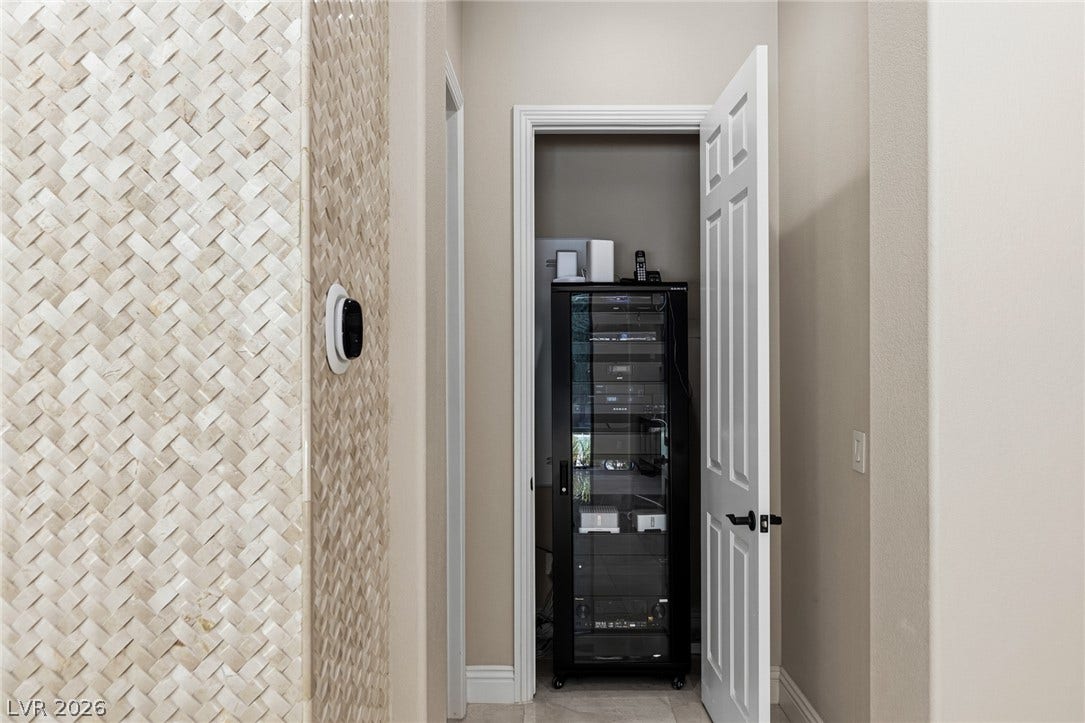 204 Satin Mist Court, Las Vegas, NV 89144 Textured wall finishes and clean architectural lines define this functional hallway storage space.
