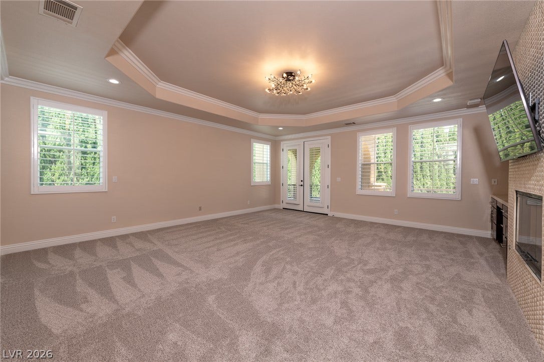 204 Satin Mist Court, Las Vegas, NV 89144 An elegant tray ceiling with crown molding rises above this comfortable carpeted space.