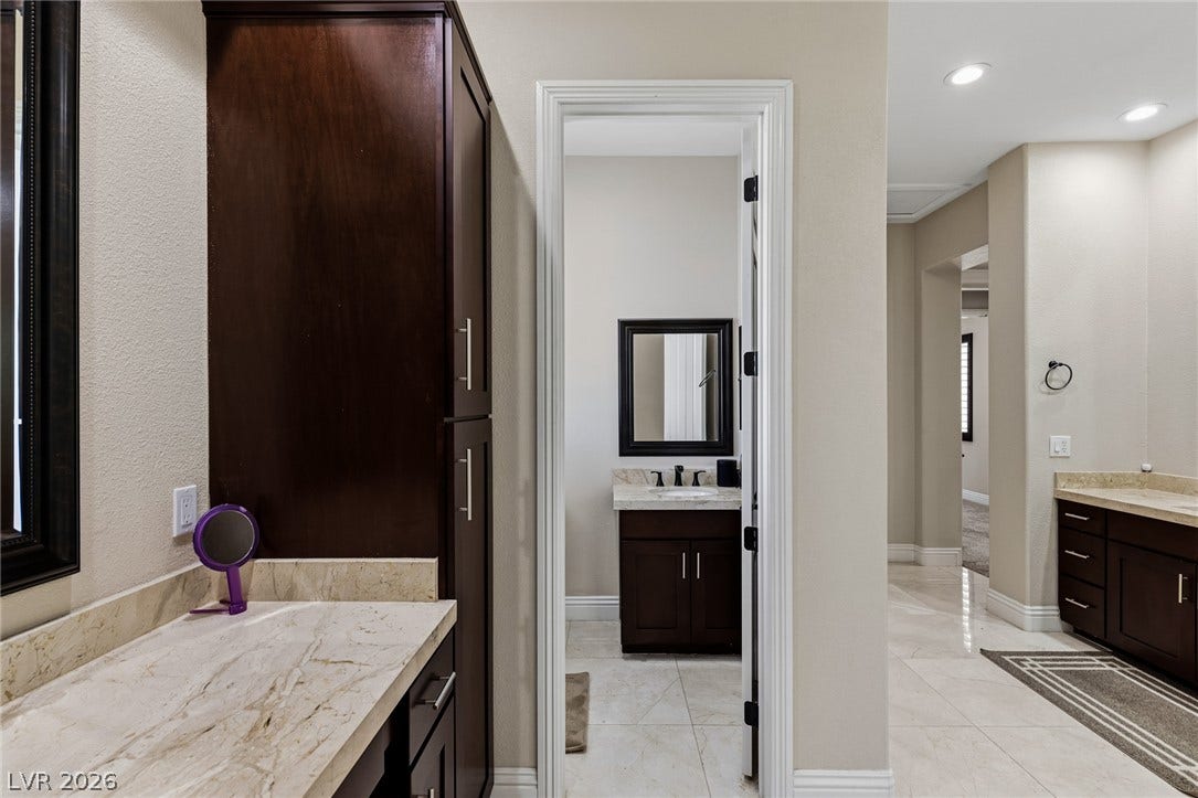 204 Satin Mist Court, Las Vegas, NV 89144 Rich dark wood cabinets pair beautifully with polished stone countertops in this spacious layout.