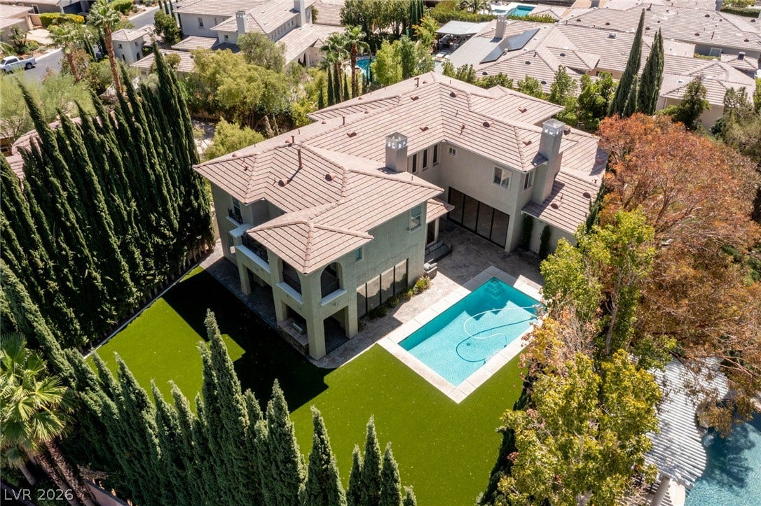 204 Satin Mist Court, Las Vegas, NV 89144 An aerial perspective captures the tiled roofline and structured backyard featuring a private swimming pool.