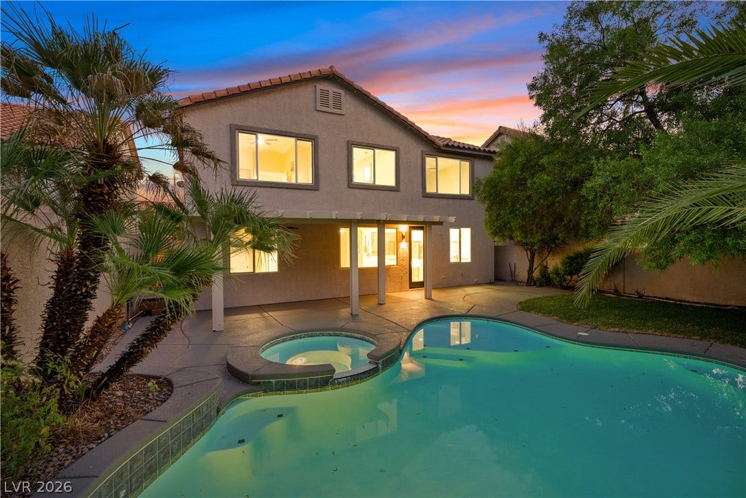 1662 Ravanusa Drive, Henderson, NV 89052 An inviting backyard oasis showcases a swimming pool and spa adjacent to a covered patio.