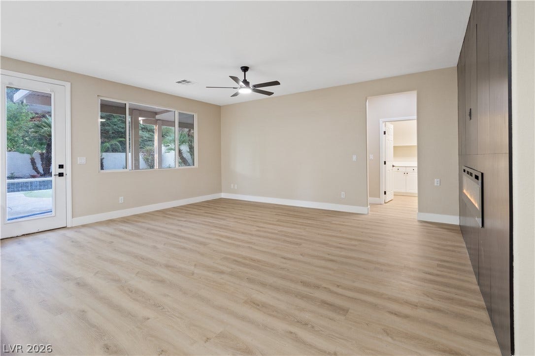 1662 Ravanusa Drive, Henderson, NV 89052 Smooth wood-look flooring and a modern linear fireplace define this versatile living space.