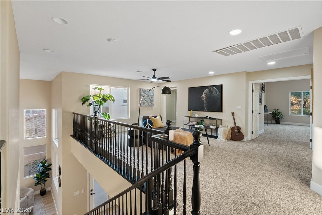 1662 Ravanusa Drive, Henderson, NV 89052 An open upstairs loft overlooks the lower level through a classic balustrade railing.