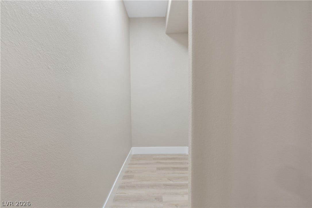 1662 Ravanusa Drive, Henderson, NV 89052 Smooth neutral walls and wood-look flooring define this versatile alcove space.