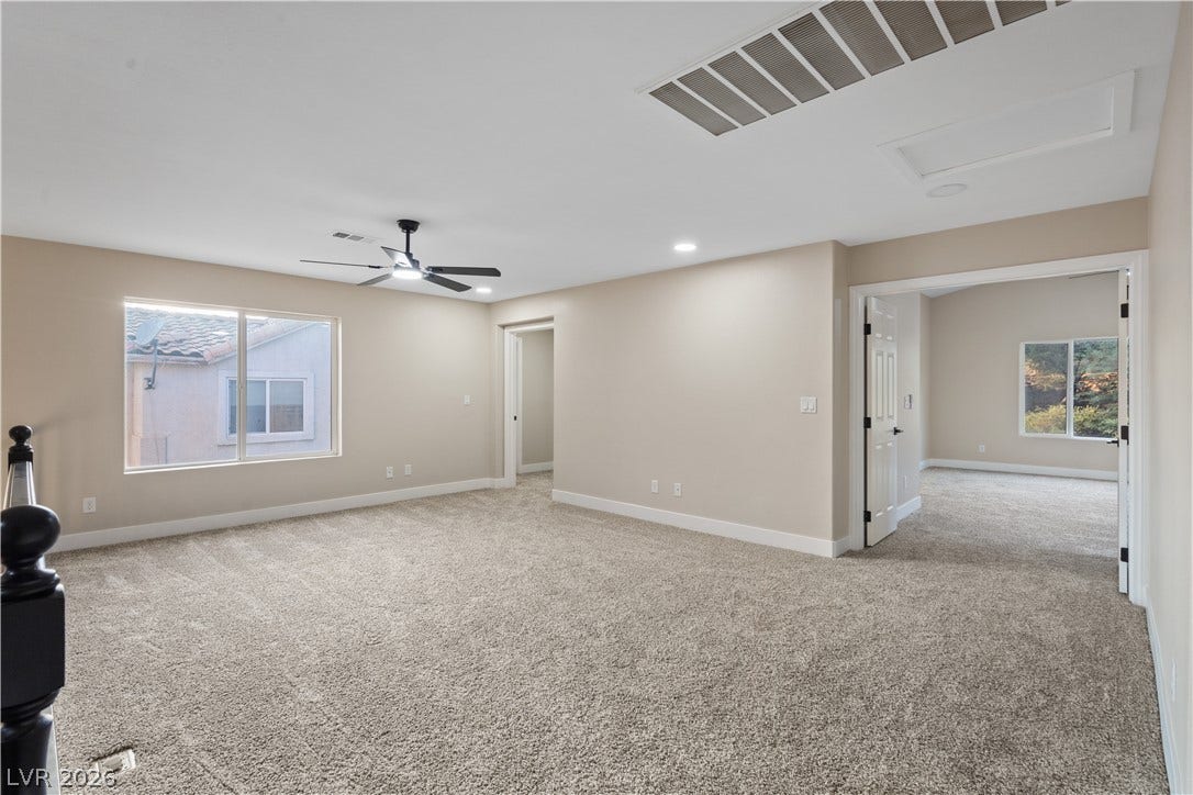 1662 Ravanusa Drive, Henderson, NV 89052 Plush carpeting anchors this versatile upstairs loft area framed by wide entryways.