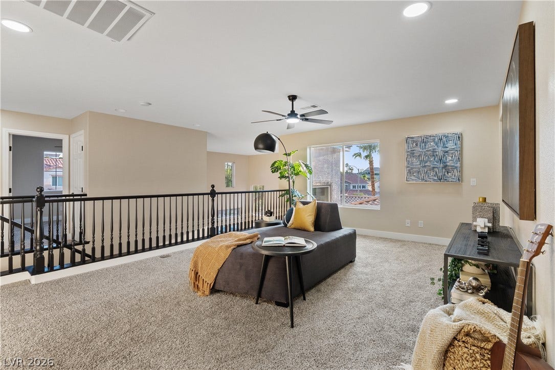 1662 Ravanusa Drive, Henderson, NV 89052 An airy upper-level loft features wall-to-wall carpeting and recessed lighting overlooking the staircase.