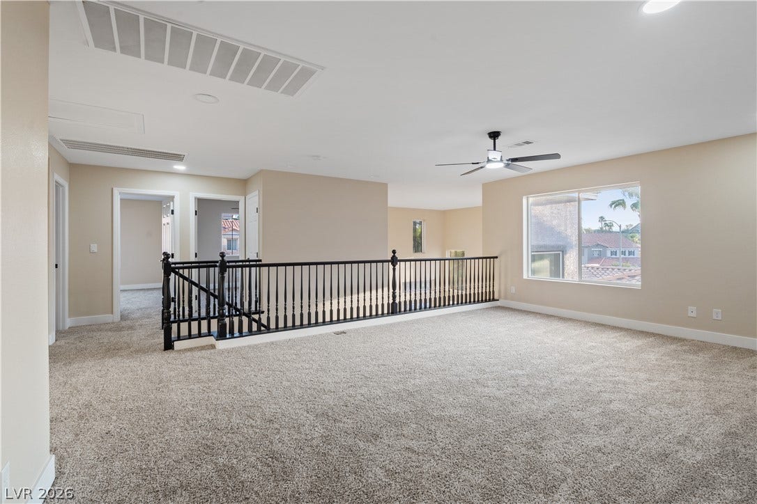 1662 Ravanusa Drive, Henderson, NV 89052 Plush carpeting and large windows define this versatile second-floor landing area.