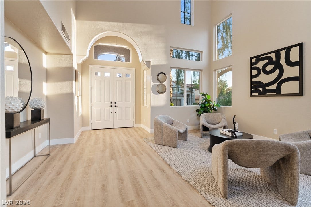 1662 Ravanusa Drive, Henderson, NV 89052 Sunlight streams across the smooth wood floors and towering ceilings of this welcoming entryway.