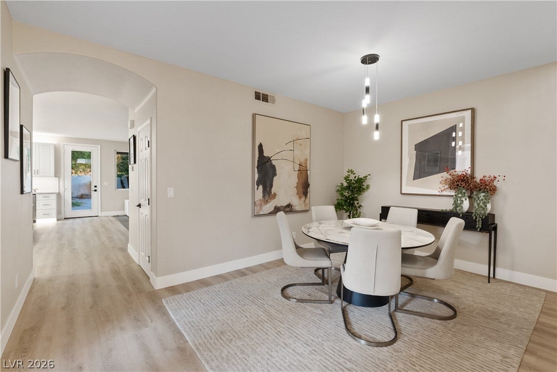 1662 Ravanusa Drive, Henderson, NV 89052 An arched doorway leads into this dining space featuring light wood-style flooring.