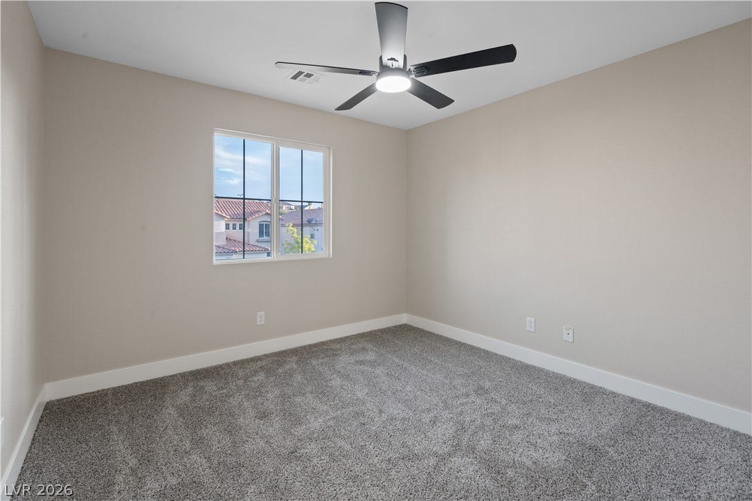 1662 Ravanusa Drive, Henderson, NV 89052 Plush wall-to-wall carpeting and clean baseboards define this serene secondary bedroom.