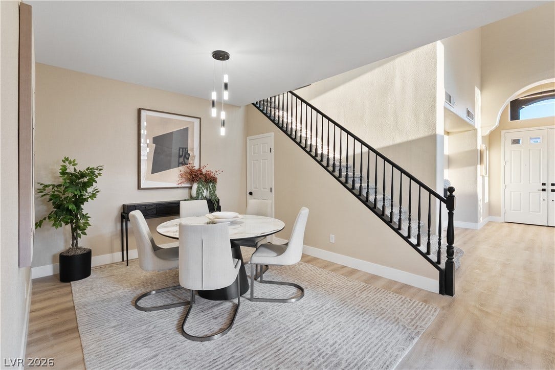 1662 Ravanusa Drive, Henderson, NV 89052 Smooth wood floors and a light-filled staircase frame this inviting dining area.