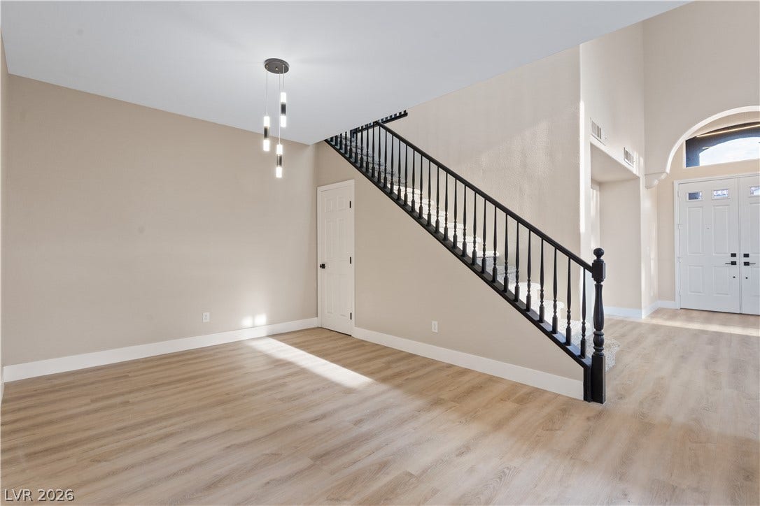 1662 Ravanusa Drive, Henderson, NV 89052 Gleaming wood-look floors complement a soaring entryway and a classic banister staircase.