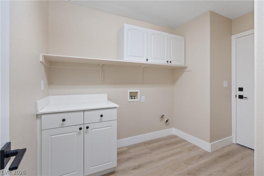 1662 Ravanusa Drive, Henderson, NV 89052 Ample cabinetry and durable wood-look flooring define this functional utility space.