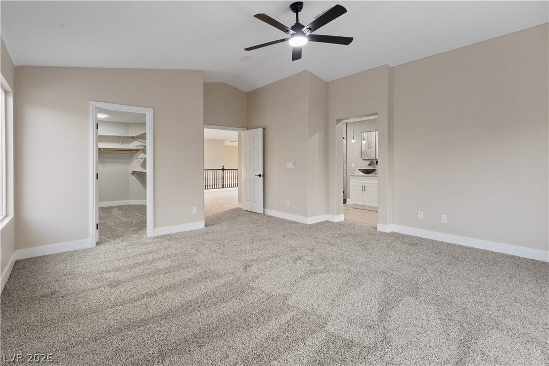 1662 Ravanusa Drive, Henderson, NV 89052 High vaulted ceilings and plush carpeting anchor this spacious suite with an attached bath.