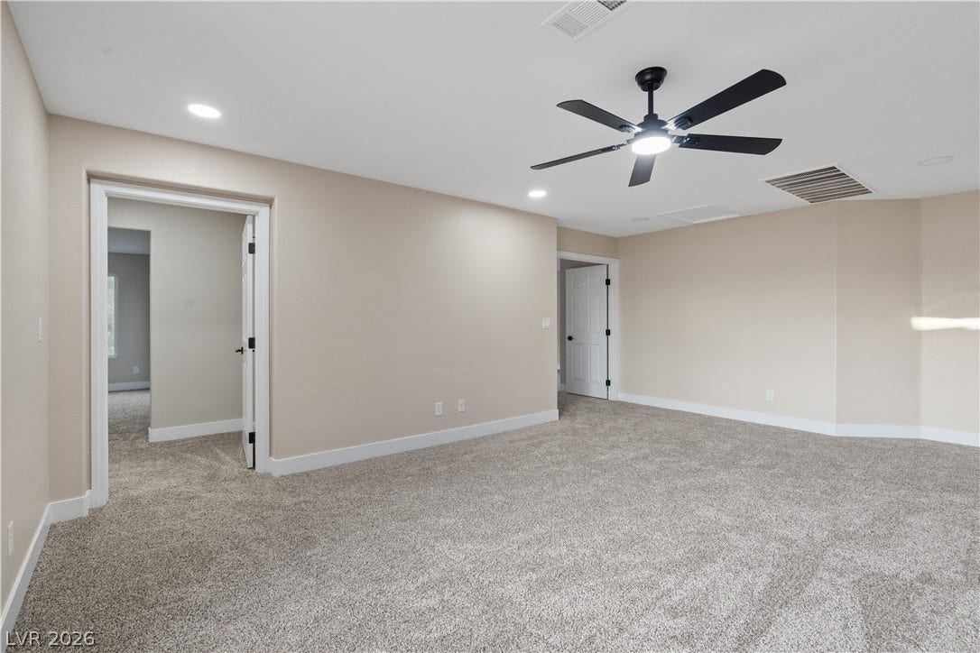 1662 Ravanusa Drive, Henderson, NV 89052 Plush carpeting and recessed lighting create a comfortable atmosphere throughout this versatile space.