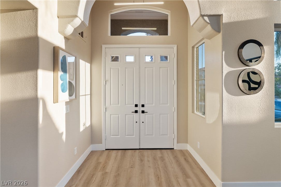 1662 Ravanusa Drive, Henderson, NV 89052 Arched architectural details frame a welcoming foyer with elegant double entry doors.