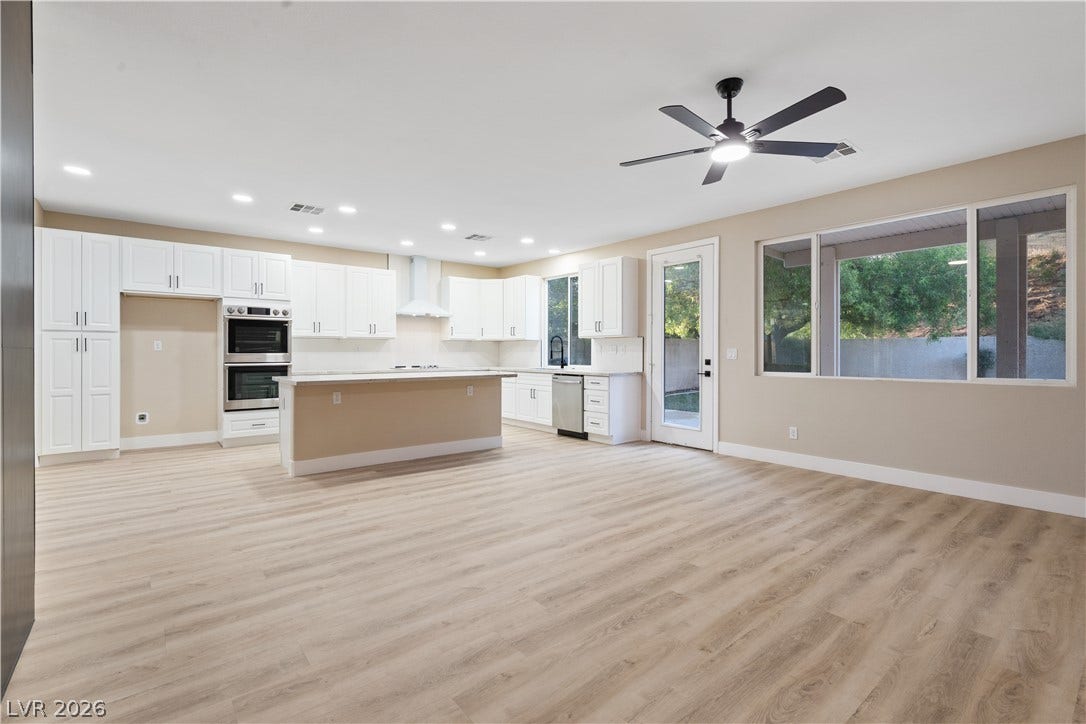 1662 Ravanusa Drive, Henderson, NV 89052 Polished hard-surface flooring anchors this airy, open-concept culinary space and living area.