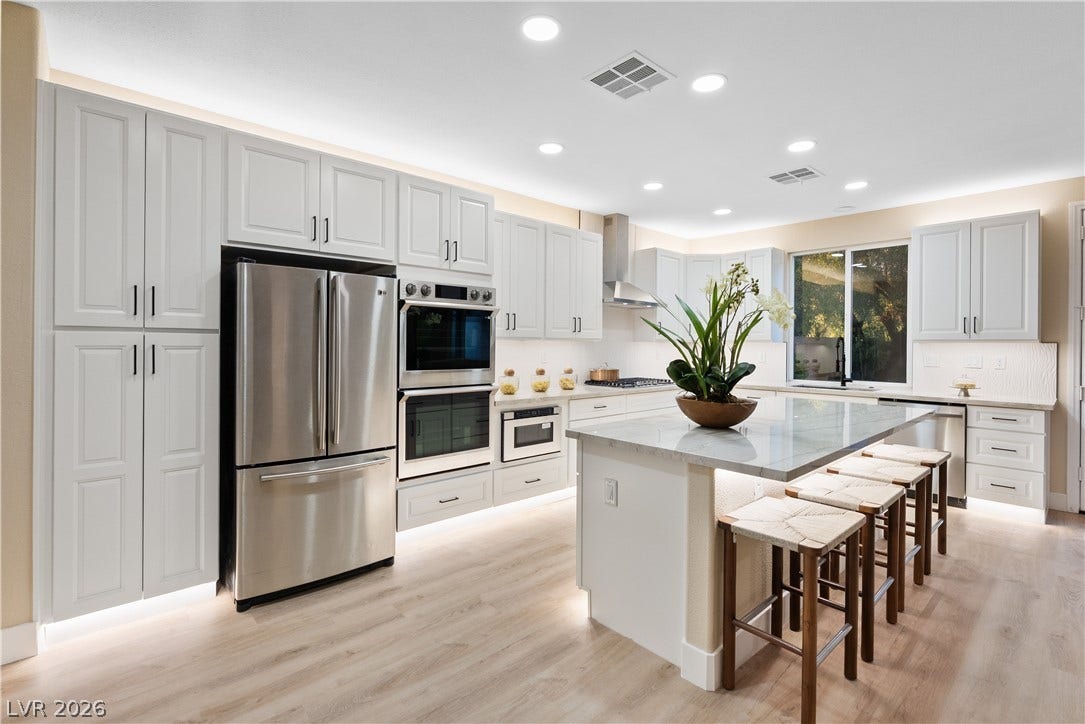 1662 Ravanusa Drive, Henderson, NV 89052 Gleaming stone countertops and stainless steel appliances elevate this modern cooking space.