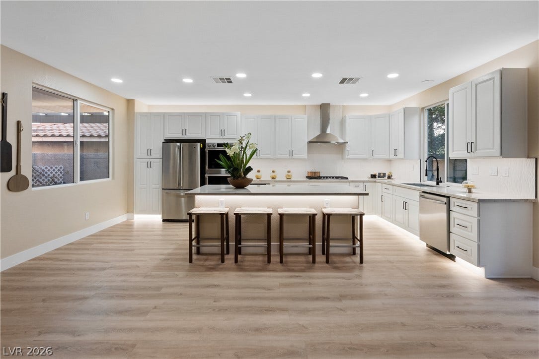 1662 Ravanusa Drive, Henderson, NV 89052 Recessed lighting and resilient wood-look flooring anchors this open, modern cooking area.