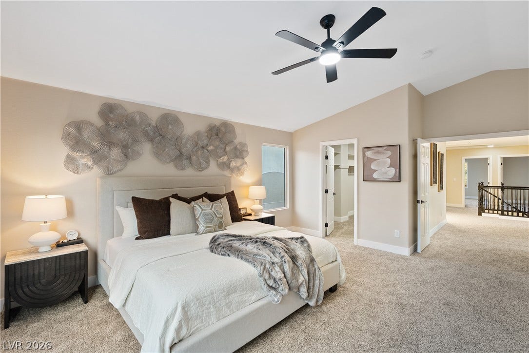1662 Ravanusa Drive, Henderson, NV 89052 Vaulted ceilings and soft carpeting create a serene and airy atmosphere in this main bedroom.