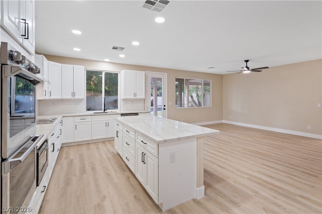 1662 Ravanusa Drive, Henderson, NV 89052 An open floorplan seamlessly connects the modern kitchen with the adjacent living space.