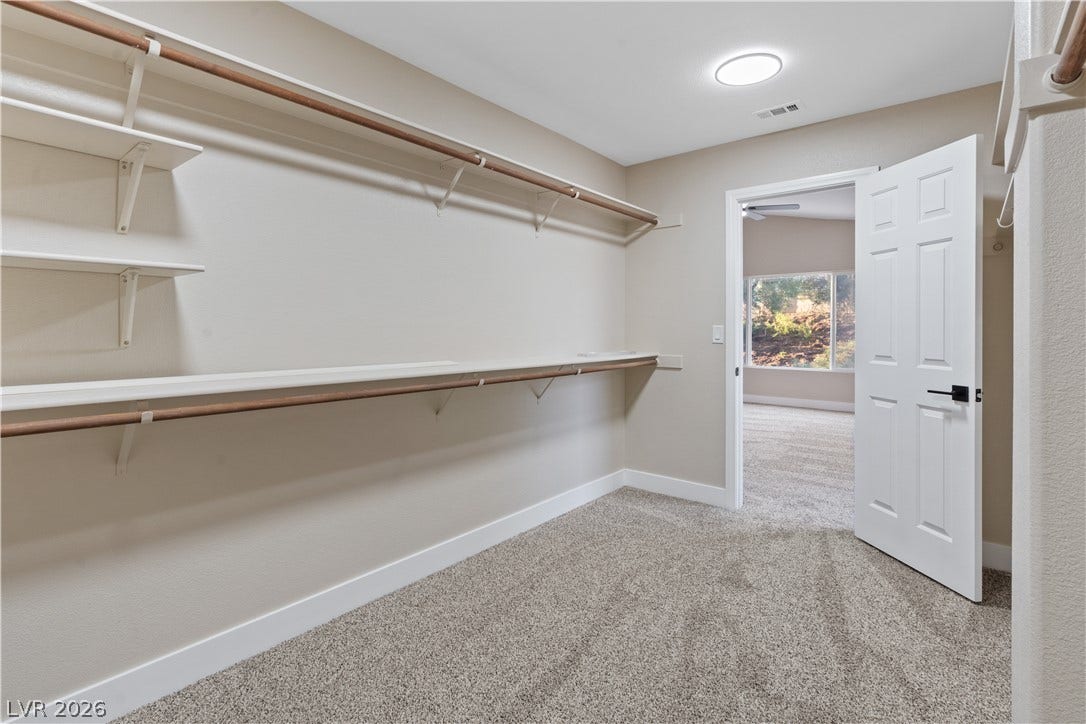1662 Ravanusa Drive, Henderson, NV 89052 An organized walk-in closet boasts ample built-in shelving and plush wall-to-wall carpeting.
