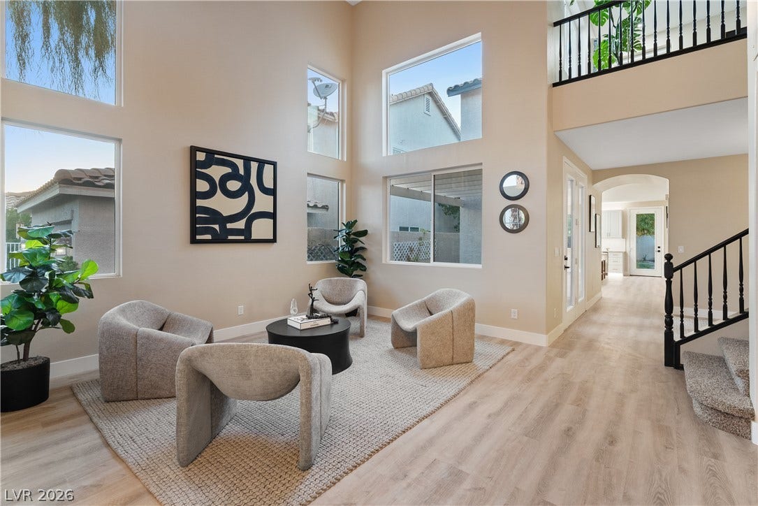1662 Ravanusa Drive, Henderson, NV 89052 Double-height ceilings and tall windows bring remarkable scale to this light-filled entry and living space.