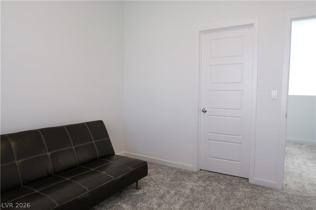 Plush carpeting anchors this versatile secondary bedroom or home office space.