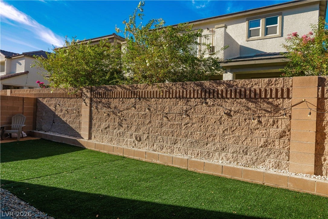 High block walls provide excellent privacy for this low-maintenance backyard retreat.