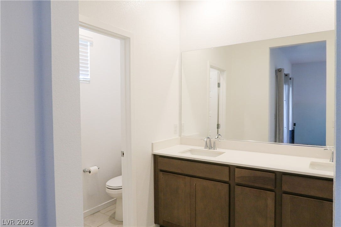 Clean lines and a spacious dual vanity define this modern bathroom.