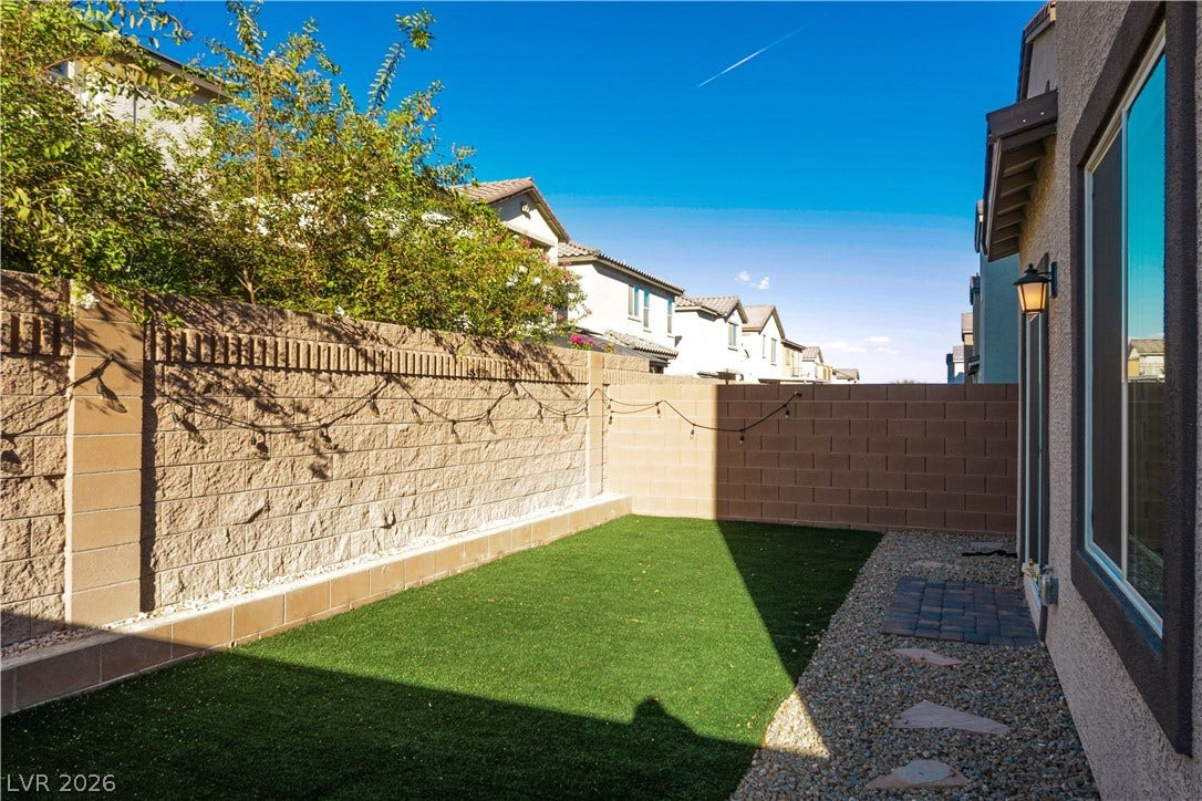 High block walls provide excellent privacy for this tidy, low-maintenance backyard space.