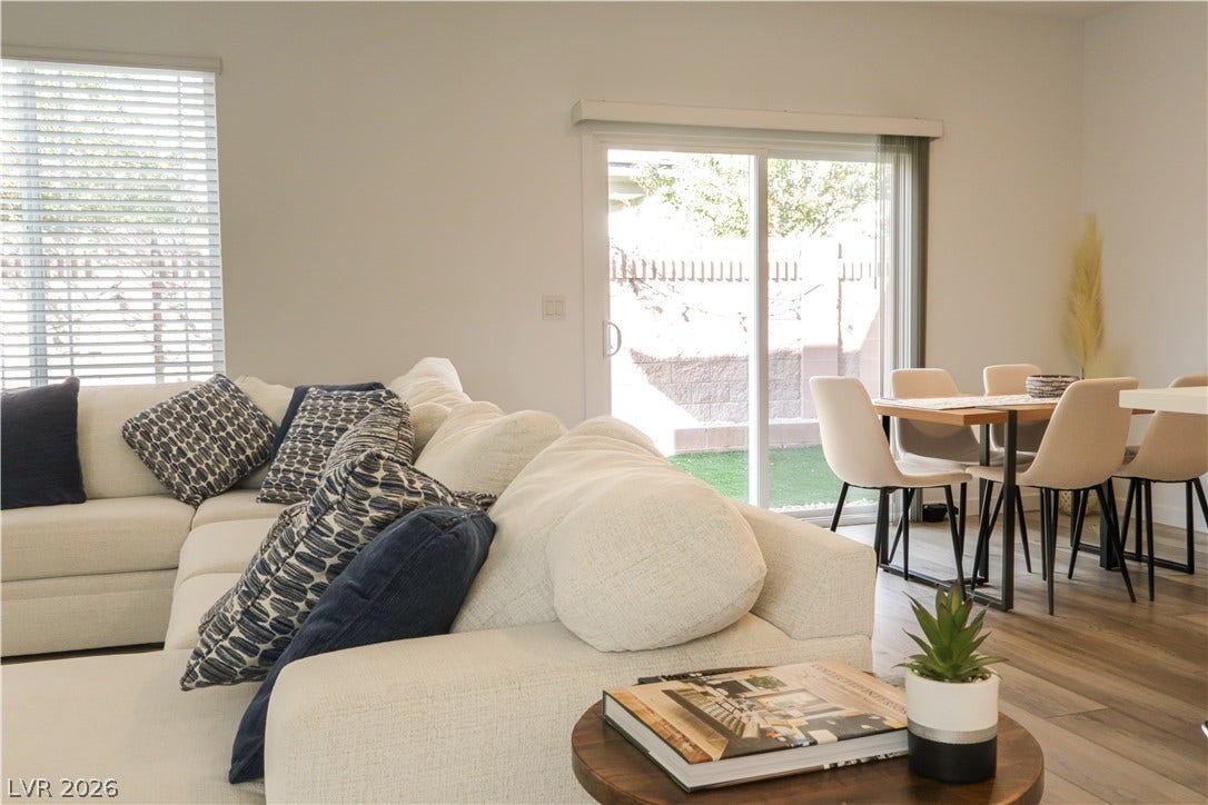 Sliding glass doors open directly to the outdoor yard from this seamless living area.
