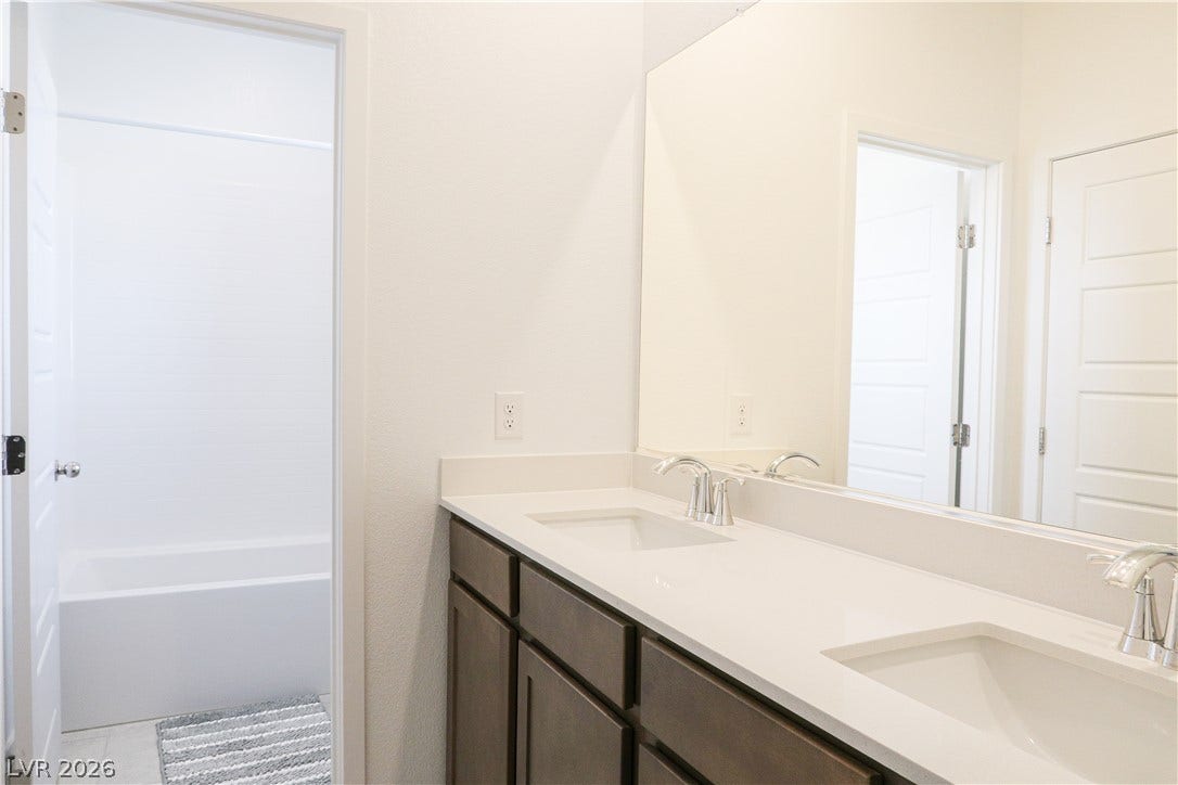 Clean lines and a spacious dual vanity define this modern bathroom layout.