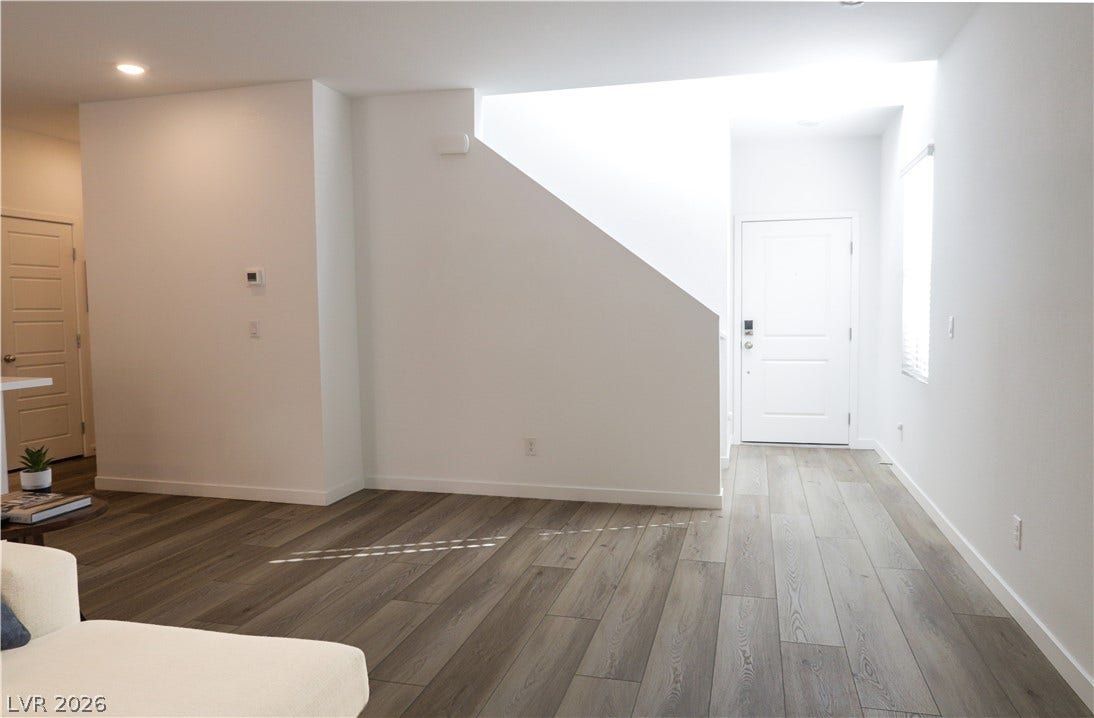 An inviting entry foyer transitions seamlessly into the main living space with gorgeous wood-look flooring.